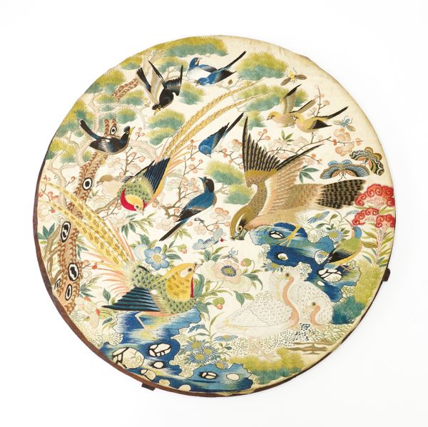 A CHINESE SILK EMBROIDERED CIRCULAR PANEL DEPICTING VARIOUS EXOTIC BIRDS (2)