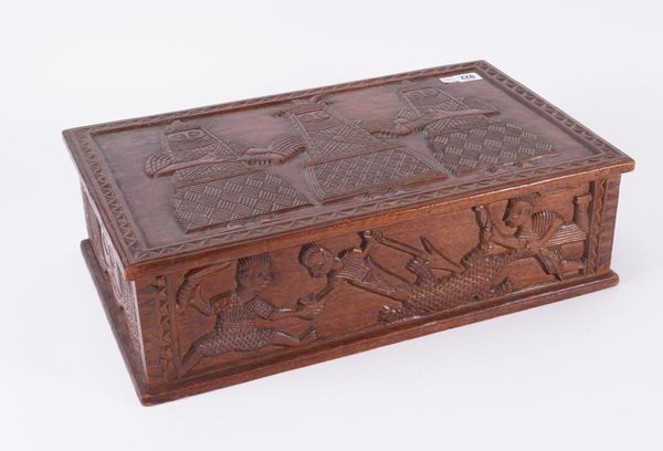 A 19TH CENTURY HARDWOOD RECTANGULAR LIFT-TOP BOX WITH VISIBLE DOVETAILS, EXTENSIVLEY CARVED WITH TRIBAL FIGURES, POSSIBLY SOUTH AMERICAN