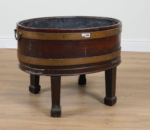 A GEORGE III BRASS BOUND COOPERED OVAL MAHOGANY WINE COOLER ON STAND