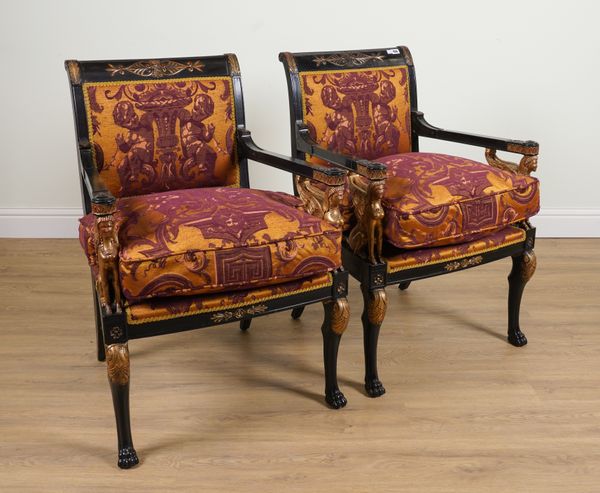 A PAIR OF EMPIRE REVIVAL PARCEL GILT EBONISED OPEN ARMCHAIRS WITH WINGED SPHINX ARM SUPPORTS (2)