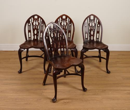 A SET OF FOUR 20TH CENTURY ELM SEATED GOTHIC BACK WINDSOR CHAIRS WITH CRINOLINE STRETCHERS (4)