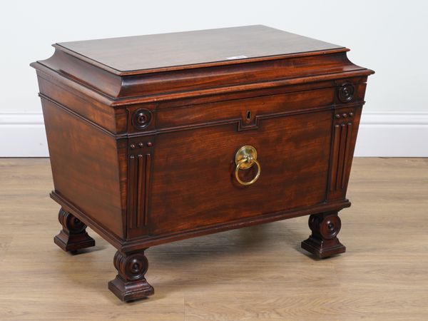 A REGENCY MAHOGANY SARCOPHAGUS FORM CELLARETTE WITH BULL’S EYE MOUNTS