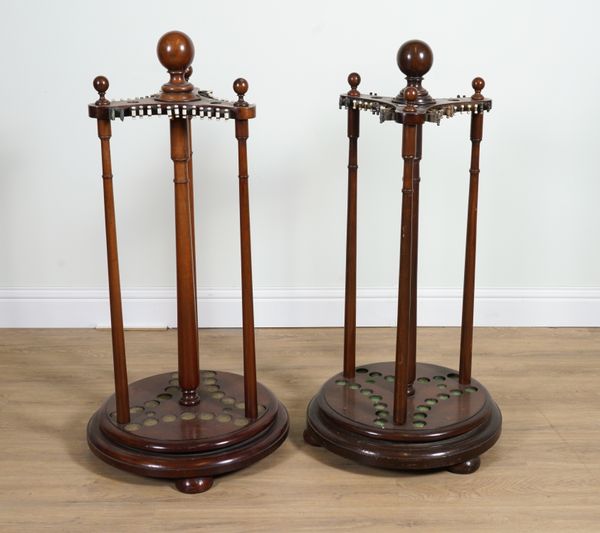 A PAIR OF MAHOGANY ROTATING CUE STANDS (2)