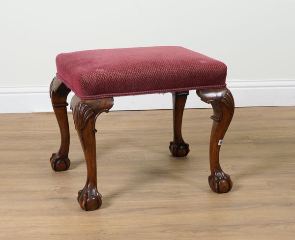 A GEORGE III STYLE WALNUT FRAMED RECTANGULAR FOOTSTOOL ON CLAW AND BALL FEET