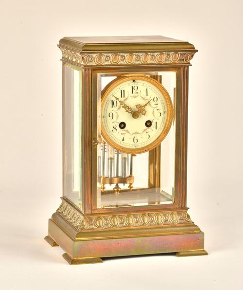 A FRENCH BRASS FOUR GLASS MANTEL CLOCK