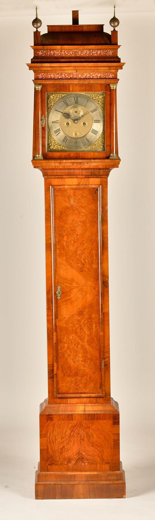 A GEORGE I WALNUT STRIKING LONGCASE CLOCK