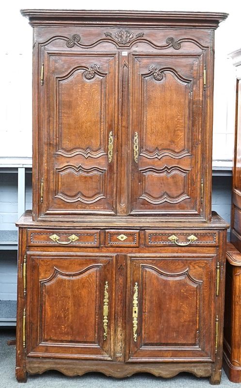 A French carved oak and chestnut double height buffet