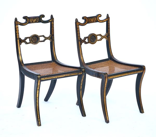 A pair of Regency parcel gilt ebonized side chairs