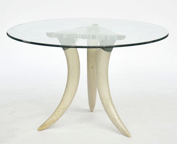 A circular glass topped occasional table