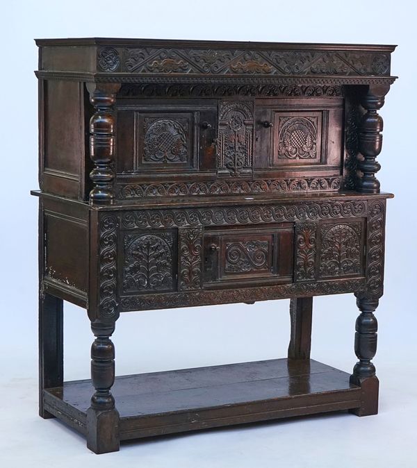 A carved oak court cupboard