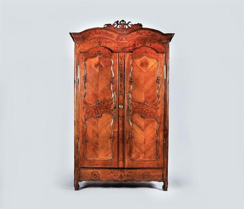A SWISS 18TH CENTURY CHESTNUT DOUBLE-ARCHED TOP TWO DOOR ARMOIRE