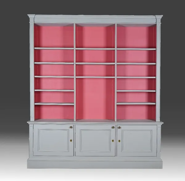 A grey-painted open bookcase cabinet