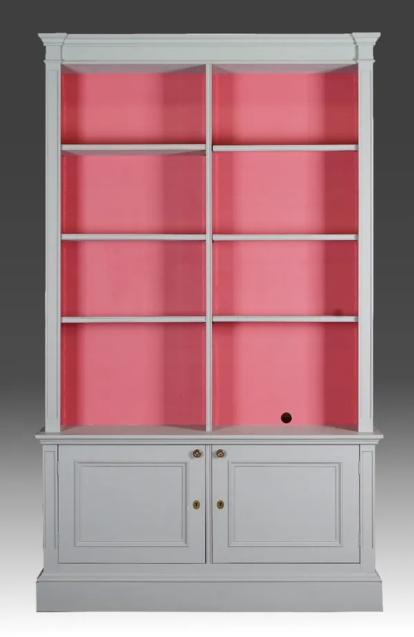 A grey-painted open bookcase cabinet