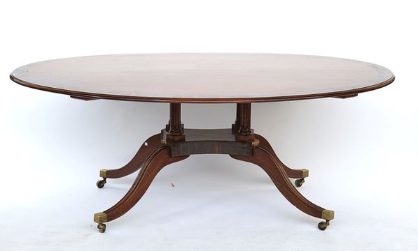 A George III style oval coromandel banded mahogany centre table