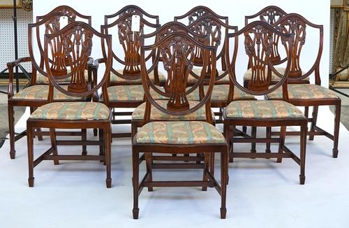 A set of twelve Hepplewhite design mahogany shield back dining chairs