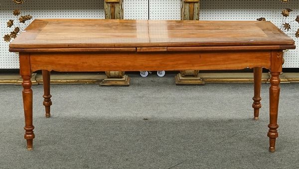 A French fruitwood draw leaf extending dining table