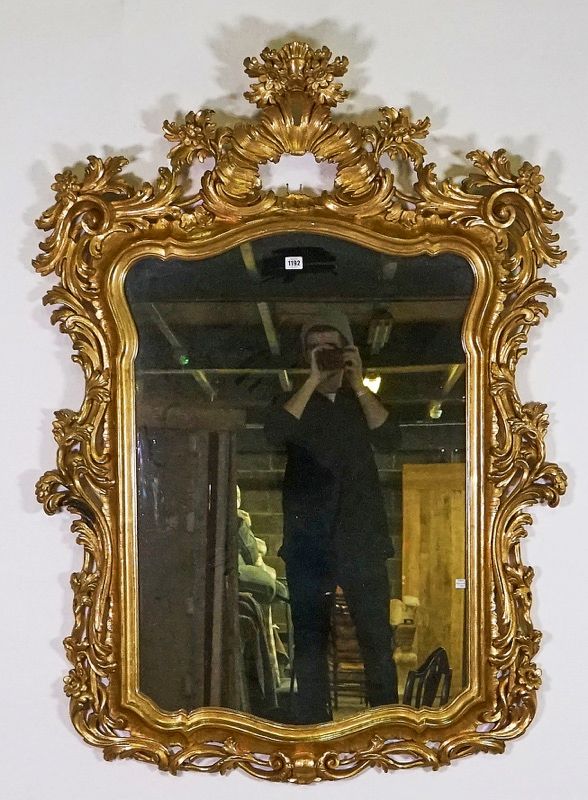 An 18th century style gilt framed shaped rectangular wall mirror