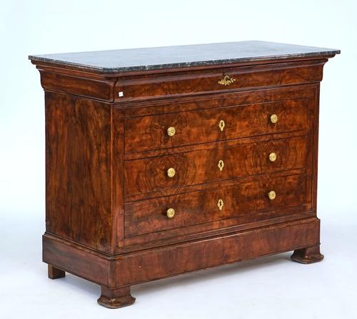 A French figured walnut four drawer commode
