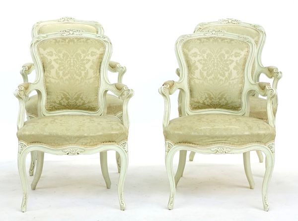 A set of four cream painted Louis XV style open armchairs