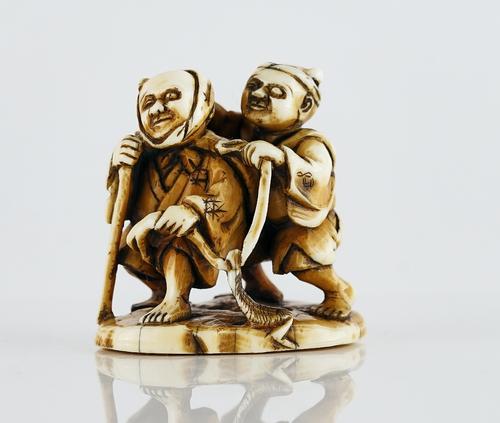 A Japanese ivory netsuke of two blind men