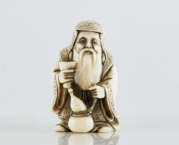 A Japanese ivory netsuke of a bearded old man