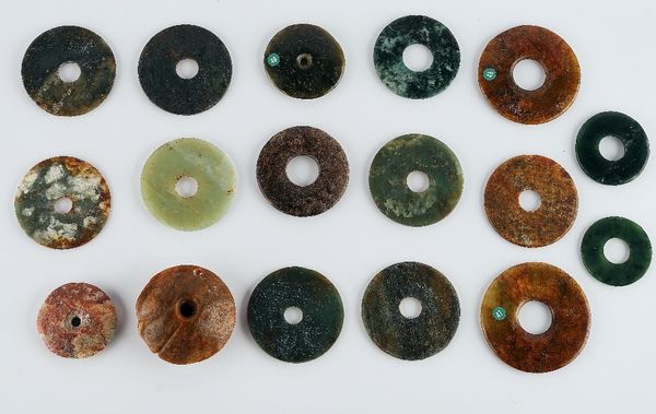 A group of sixteen Chinese archaistic jade bi discs and a weaver's weight