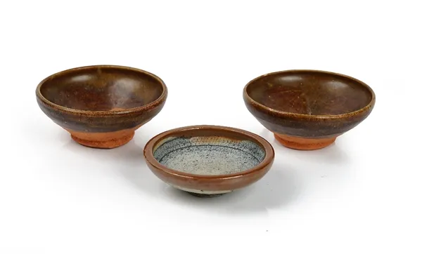 A pair of Chinese brown glazed tea bowls