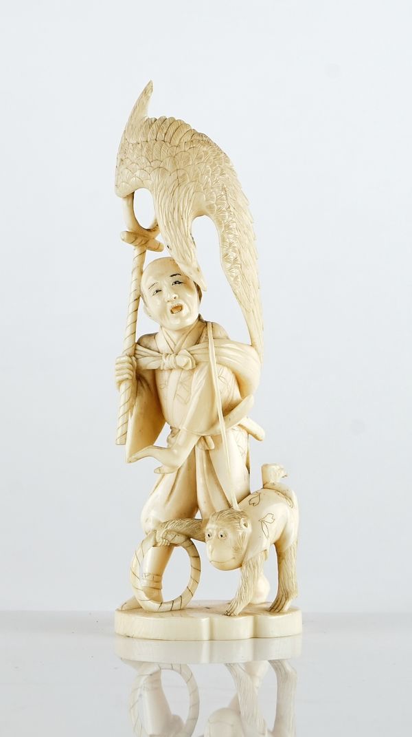 A Japanese ivory okimono of a falconer