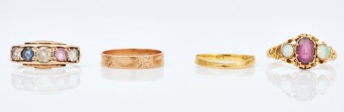 An opal and garnet set three stone ring and three other rings (4)