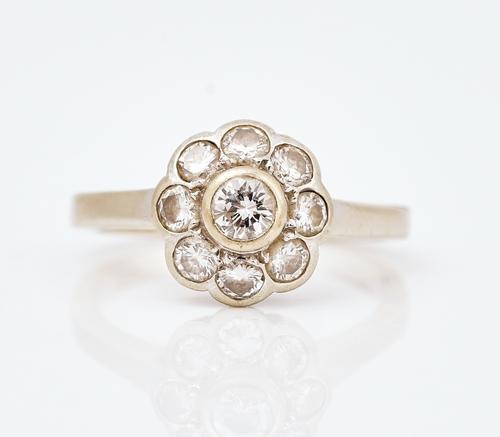 A diamond nine stone cluster ring