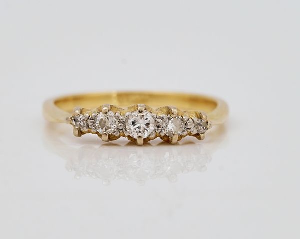 A gold and diamond set five stone ring