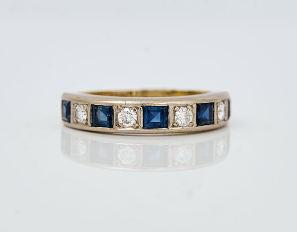 A gold, diamond and sapphire set half hoop eternity ring