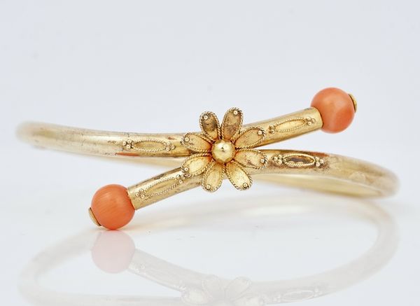 A gold and coral bangle
