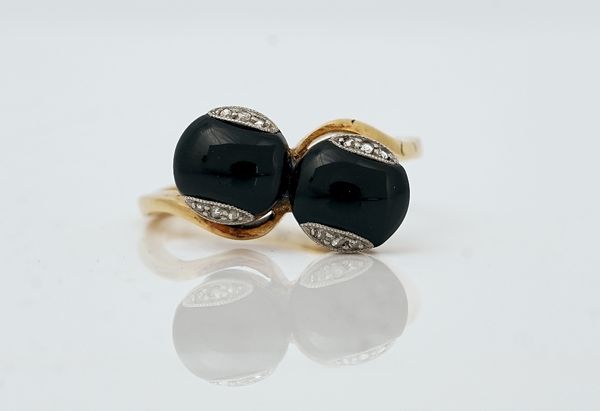 A gold, black onyx and diamond ring