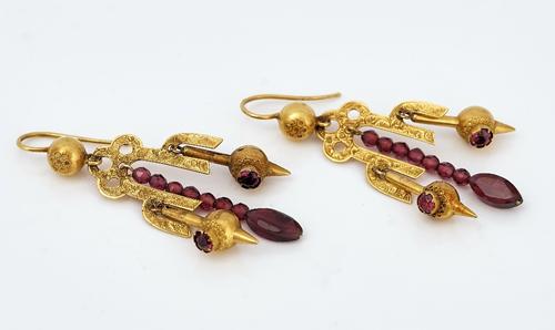 A pair of gold and red gem set drop shaped pendant earrings
