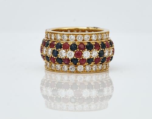 A gold, diamond, sapphire and ruby band ring