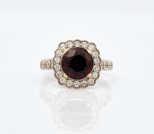 An 18ct white gold, purple spinel and diamond cluster ring