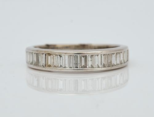 An 18ct white gold and diamond half eternity ring