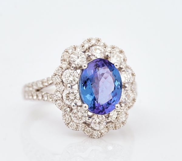 An 18ct white gold, tanzanite and diamond set cluster ring