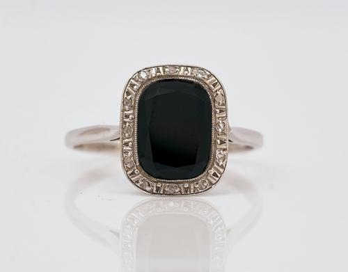 A French platinum, black onyx and diamond ring