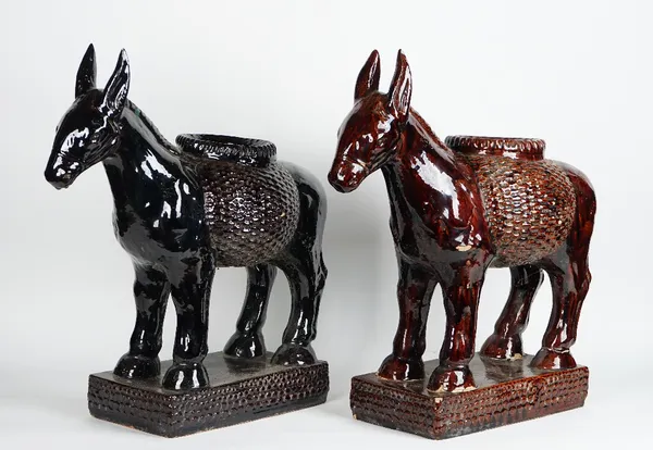 A pair of brown glazed pottery jardinieres modelled as donkeys