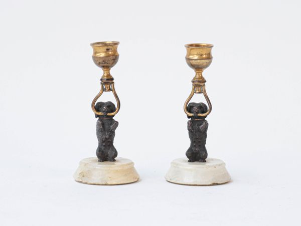 A pair of gilt-metal and white marble candlesticks