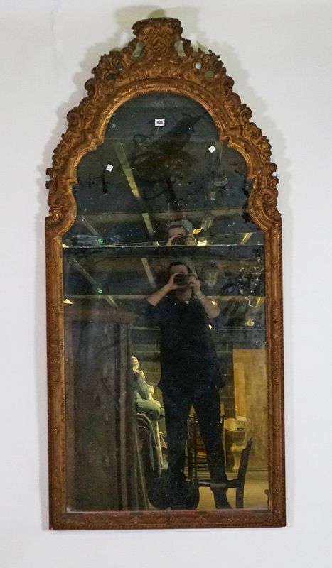 A Regence style gilt framed arch top mirror