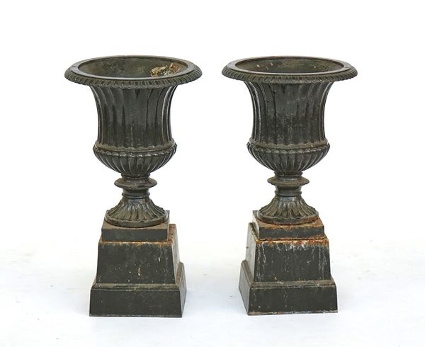 A pair of olive green painted cast iron baluster garden urns