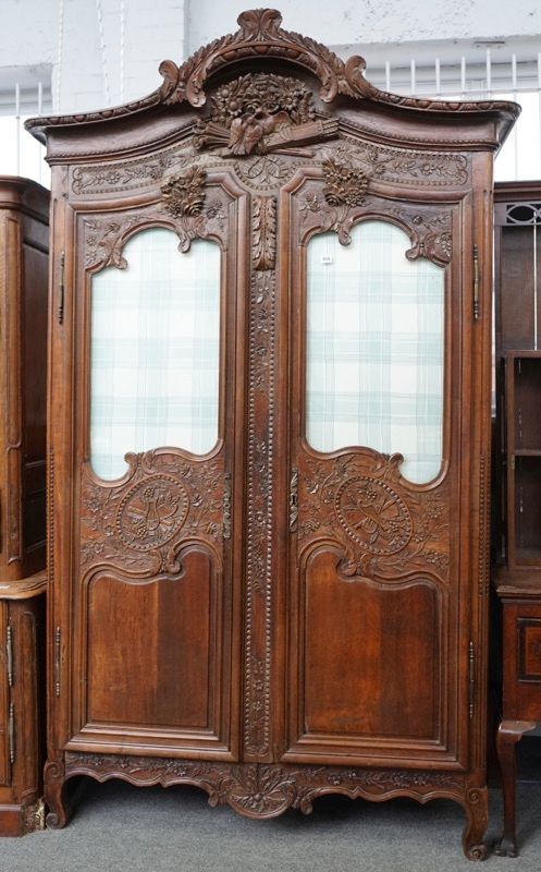 A FRENCH 18TH CENTURY CARVED OAK ARMOIRE