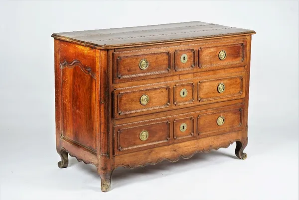 A French Provincial walnut three drawer commode