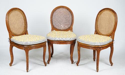 A set of six Louis XV and later caned dining chairs