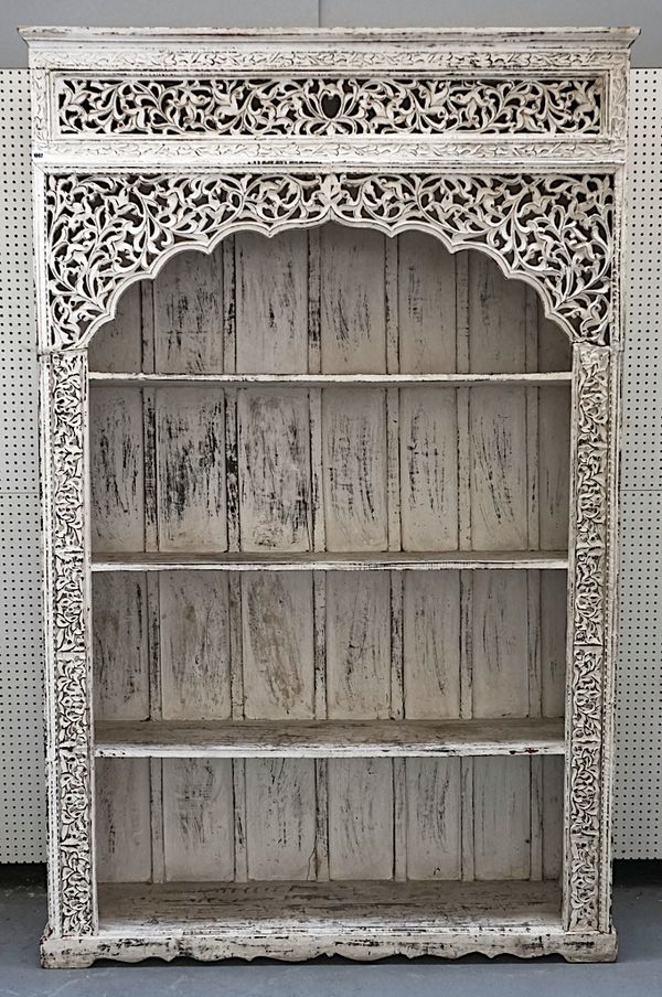 A LARGE WHITE PAINTED INDIAN CARVED HARDWOOD OPEN BOOKCASE