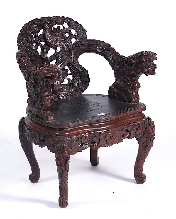 AN EARLY 20TH CENTURY CHINESE PROFUSLEY CARVED TUB BACK OPEN ARMCHAIR