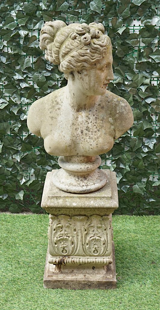 A RECONSTITUTED STONE BUST OF A GREEK WOMAN, ON TURNED SOCLE AND ACANTHUS MOULDED SQUARE BASE